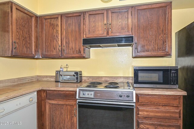 18012 N 37th Dr, Glendale, AZ 85308 - kitchen with light countertops, under cabinet range hood, stainless steel appliances, tile patterned floors, and a toaster