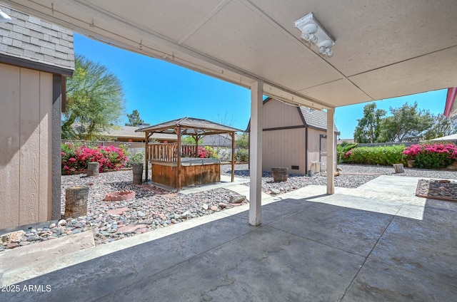 18012 N 37th Dr, Glendale, AZ 85308 - view of patio / terrace featuring an outbuilding, a jacuzzi, a gazebo, fence, and a storage unit