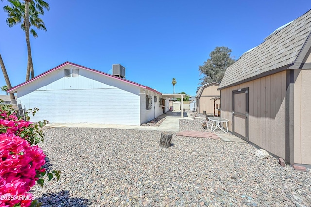 18012 N 37th Dr, Glendale, AZ 85308 - back of house featuring a patio, brick siding, and central AC unit