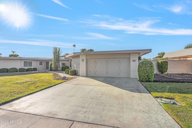 ranch-style home with a front yard and a garage