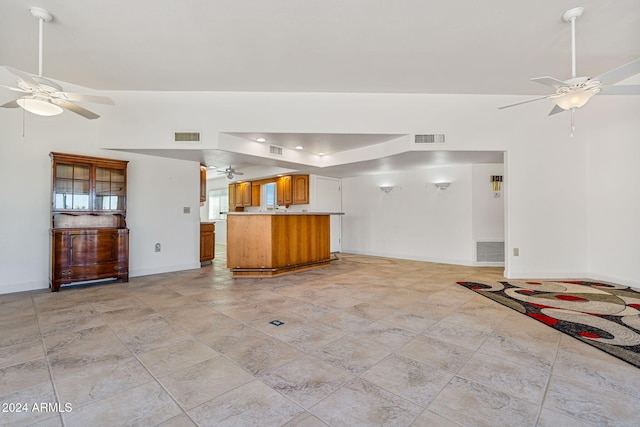 unfurnished living room featuring ceiling fan