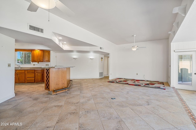 kitchen featuring a center island, sink, and ceiling fan