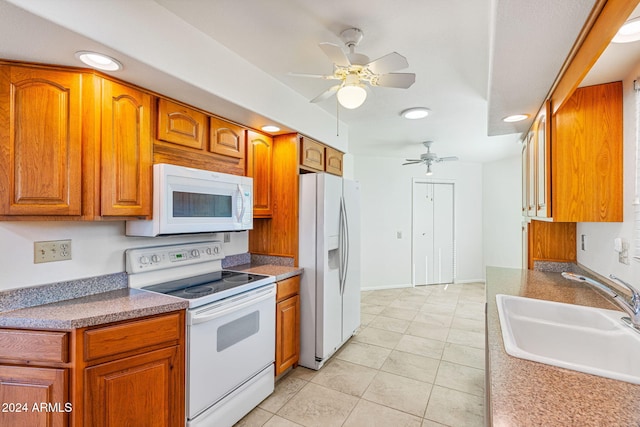 kitchen featuring light tile patterned flooring, ceiling fan, sink, and white appliances