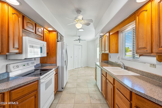 kitchen with white appliances, light tile patterned floors, sink, and ceiling fan