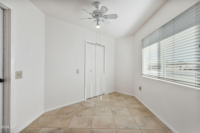 unfurnished bedroom featuring a closet and ceiling fan