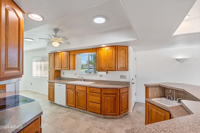 kitchen featuring a textured ceiling, sink, white dishwasher, and ceiling fan