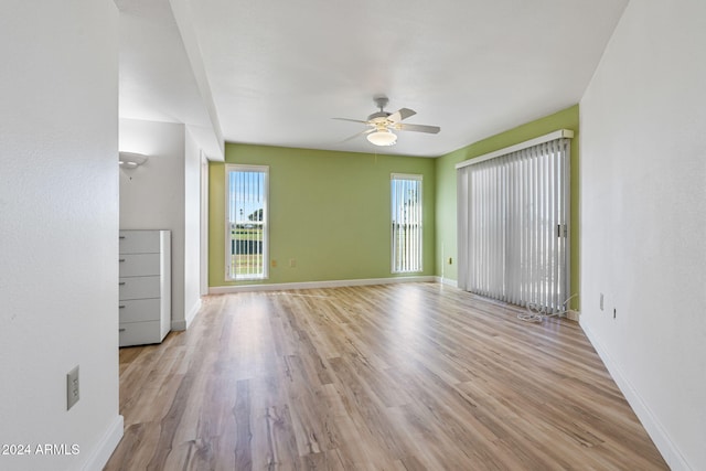 unfurnished room featuring light hardwood / wood-style flooring and ceiling fan