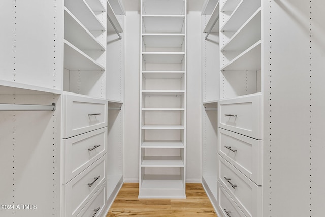 walk in closet with light wood-type flooring