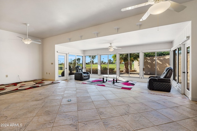 unfurnished living room featuring a wealth of natural light and ceiling fan