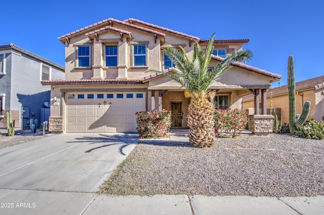 mediterranean / spanish home featuring driveway, an attached garage, and stucco siding