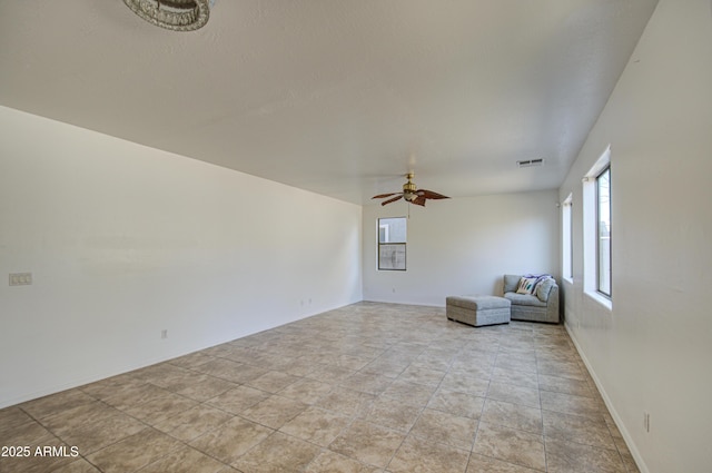 unfurnished room featuring visible vents and a ceiling fan