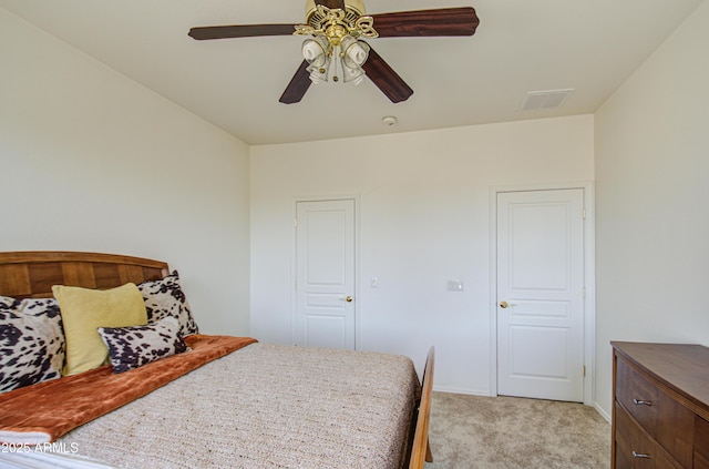 bedroom with light carpet, baseboards, visible vents, and a ceiling fan