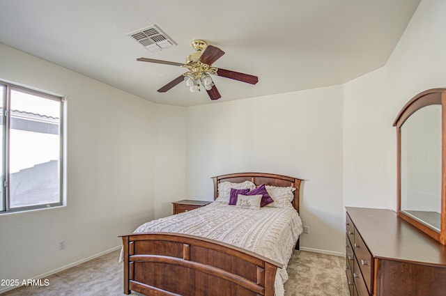 bedroom featuring baseboards, visible vents, ceiling fan, and light colored carpet