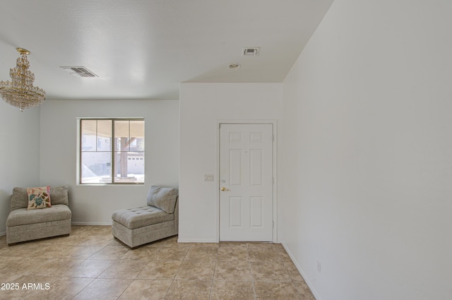 living area featuring light tile patterned floors, visible vents, and baseboards