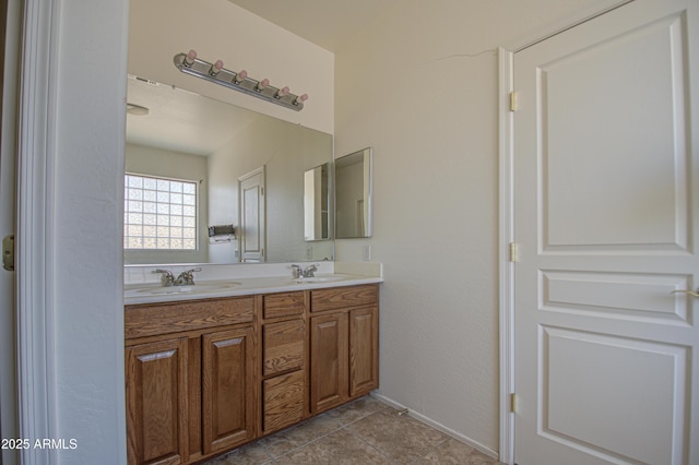 bathroom featuring double vanity, a sink, and tile patterned floors