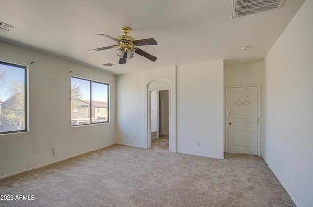 unfurnished bedroom with light carpet, visible vents, and a ceiling fan