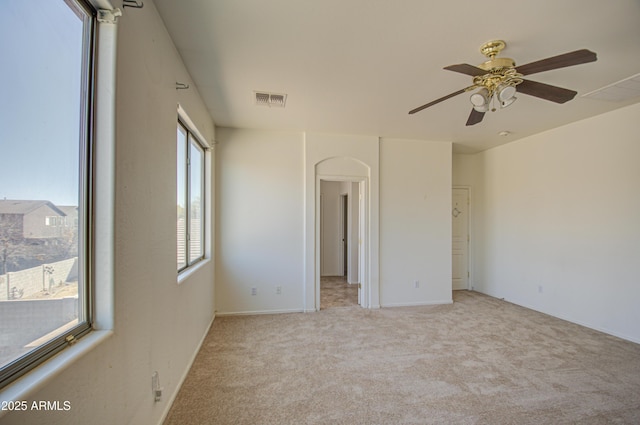 unfurnished bedroom with a ceiling fan, visible vents, and light carpet