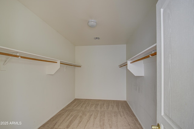 walk in closet with light carpet and visible vents