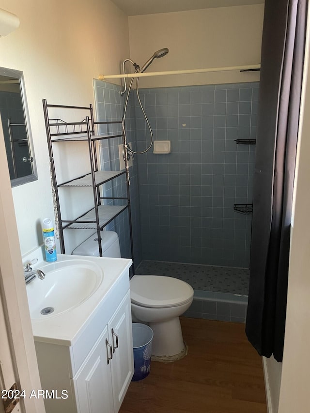 bathroom featuring vanity, hardwood / wood-style floors, toilet, and a shower with shower curtain