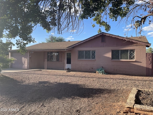 rear view of property with a garage