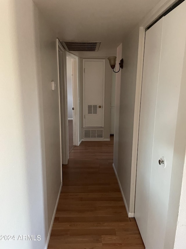 hallway with hardwood / wood-style flooring