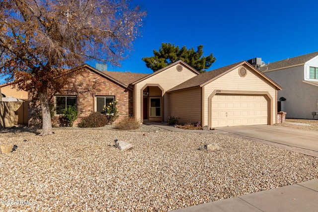 ranch-style home with a garage and central AC