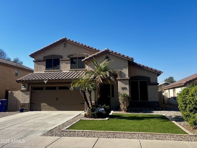 mediterranean / spanish home featuring a garage and a front yard