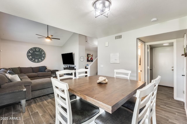 dining area with ceiling fan, dark hardwood / wood-style flooring, and a textured ceiling