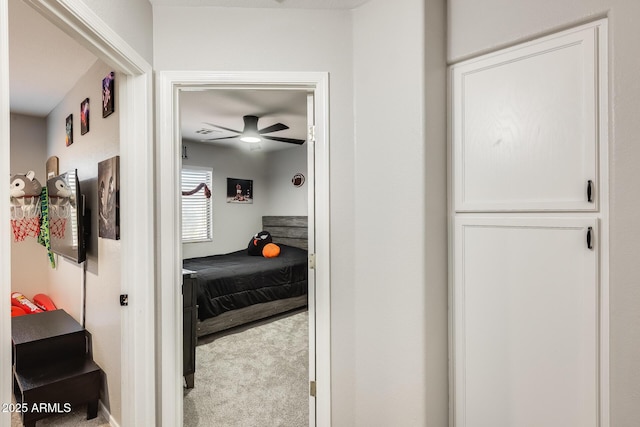 bedroom with light carpet and ceiling fan