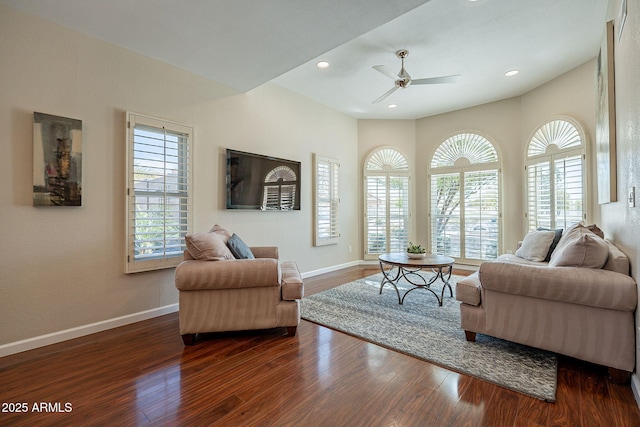 living area with dark wood-type flooring, recessed lighting, baseboards, and a ceiling fan