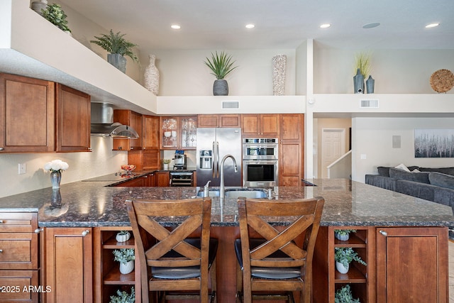 kitchen with stainless steel appliances, a breakfast bar, wall chimney exhaust hood, and open shelves