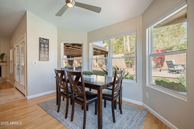 dining area with light wood-style flooring and baseboards