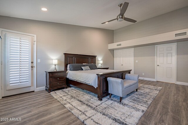 bedroom featuring wood finished floors, visible vents, and baseboards