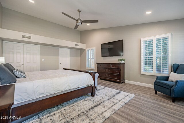 bedroom with baseboards, visible vents, vaulted ceiling, light wood-type flooring, and recessed lighting