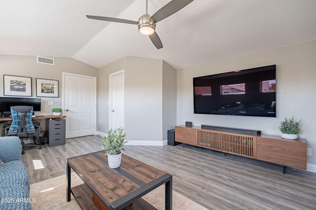 living room featuring baseboards, visible vents, lofted ceiling, ceiling fan, and wood finished floors