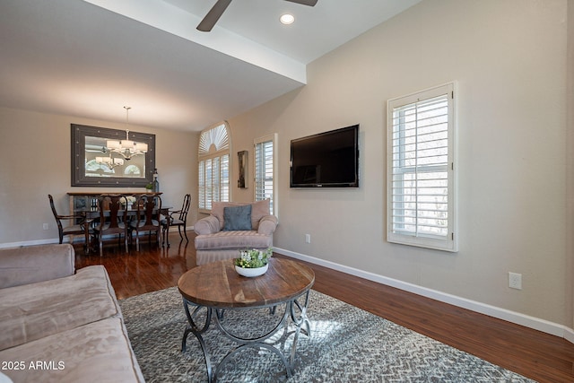 living room with ceiling fan with notable chandelier, dark wood-style flooring, recessed lighting, and baseboards