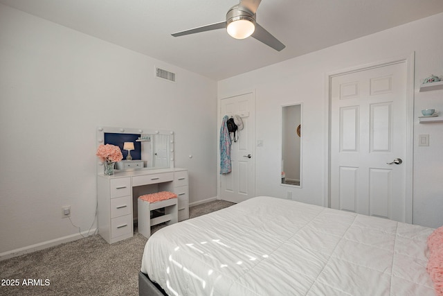 carpeted bedroom with a ceiling fan, visible vents, and baseboards