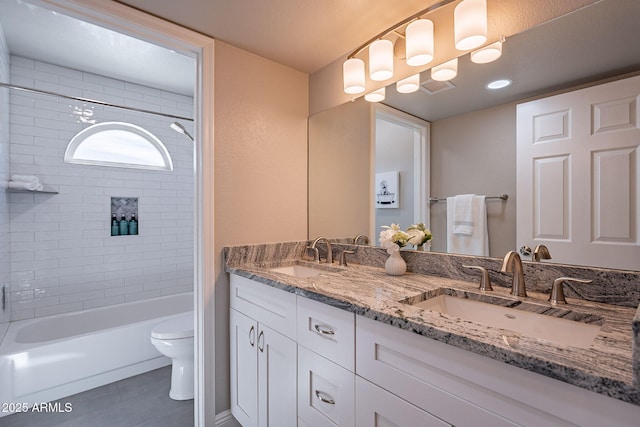 bathroom with shower / tub combination, a sink, toilet, and double vanity