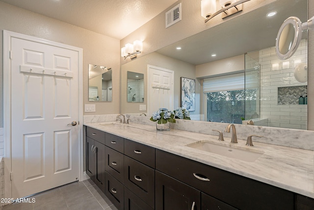 full bath with double vanity, tile patterned flooring, a sink, and visible vents