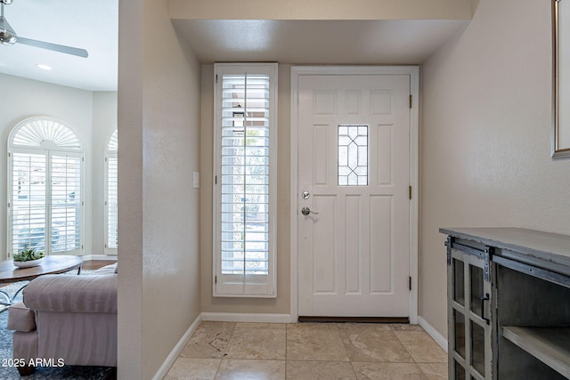 entrance foyer featuring plenty of natural light, baseboards, and ceiling fan