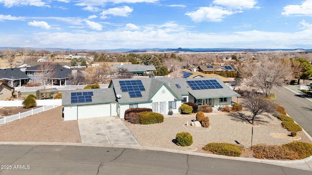 view of front of home with a garage and solar panels