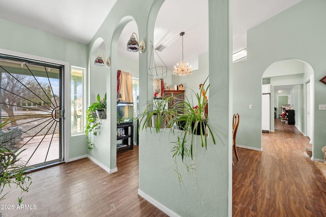 foyer featuring an inviting chandelier and wood-type flooring