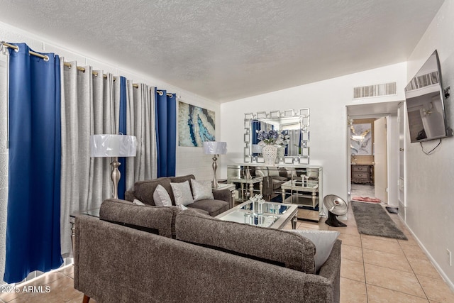 tiled living room featuring a textured ceiling