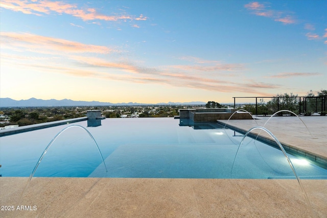 pool at dusk with a mountain view