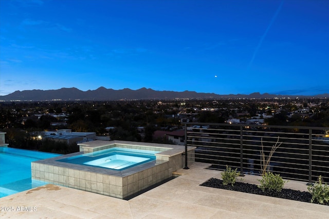 view of swimming pool featuring an in ground hot tub and a mountain view