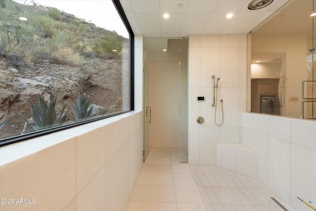 bathroom featuring walk in shower, a healthy amount of sunlight, and tile patterned flooring