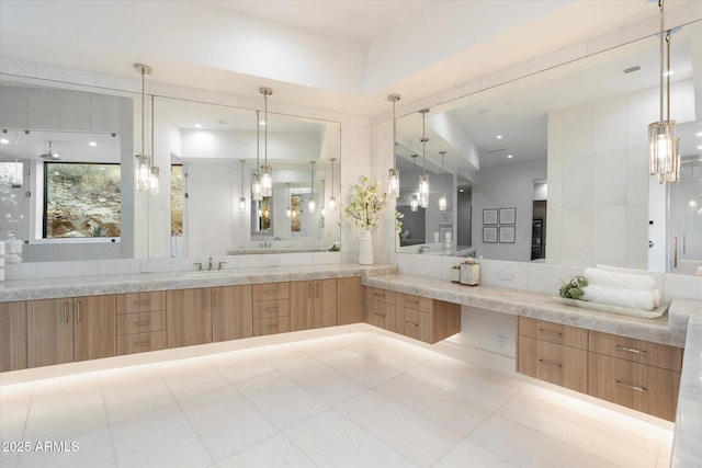 bathroom with vanity, tile patterned floors, and decorative backsplash