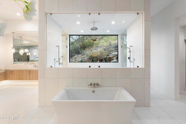 bathroom featuring tile walls, vanity, tile patterned floors, and shower with separate bathtub