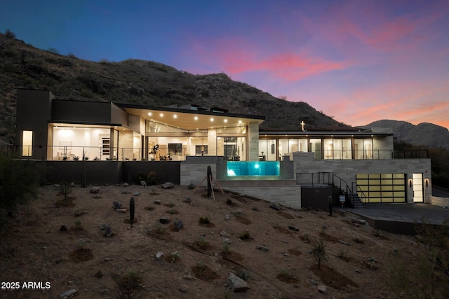 back house at dusk featuring a mountain view