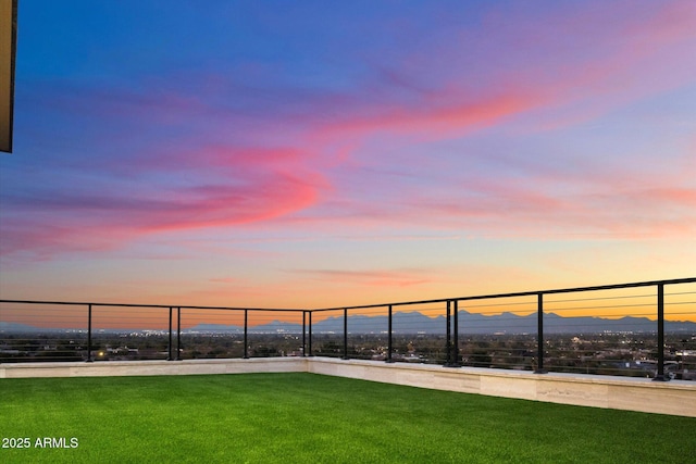 yard at dusk featuring a mountain view